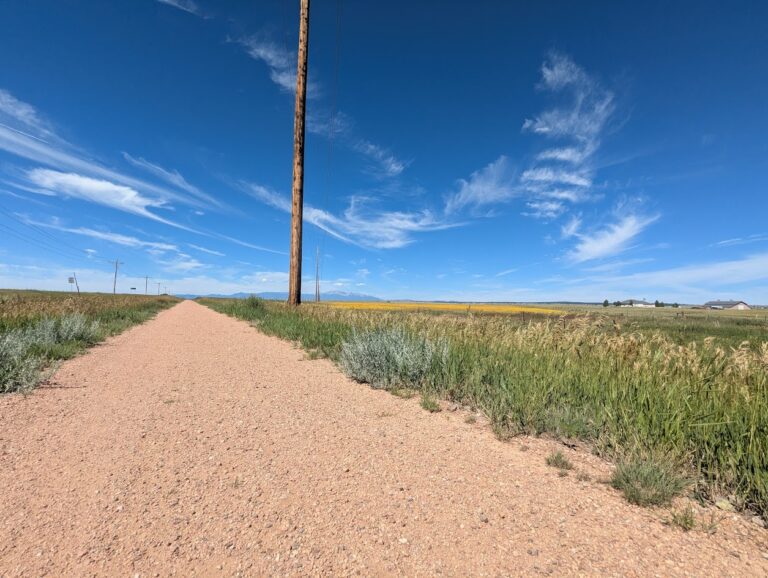 Rock Island Trail near Peyton. Wide dirt trail with prairie views.